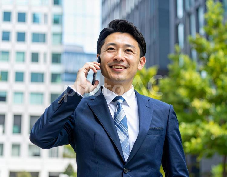 街中で電話をかけるビジネスマン ビジネス,電話,連絡の写真素材