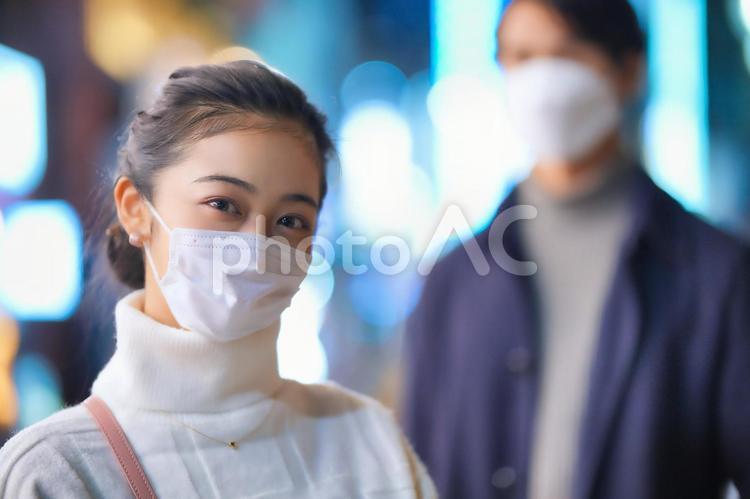 夜の街にいるマスクをしたカップル 女性,カップル,夫婦の写真素材