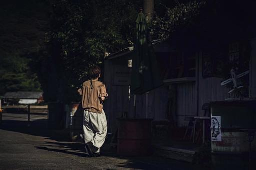 <Material> A woman strolling around a tourist spot at dusk, JPG