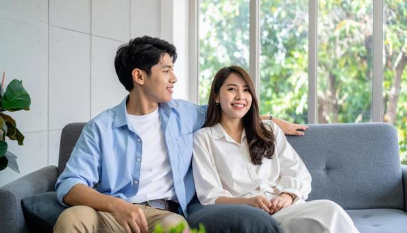 リビングでくつろぐ若いカップルの横顔 リビングでくつろぐ若いカップルの横顔の写真