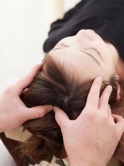 Japanese woman receiving a scalp massage Japanese woman receiving a scalp massage