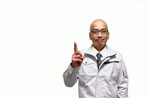 人差し指でポイント説明する作業員中年男性 人差し指でポイント説明する作業員中年男性 作業着,作業服,作業員の写真素材