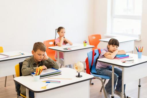 ノートや机で寝ている生徒たち 男の子,女の子,子どもの写真素材