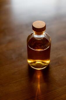 木製テーブルに置いた洋酒ボトル_縦 ウィスキー,ボトル,洋酒の写真素材