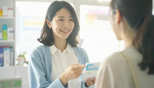 笑顔で接客する働く薬剤師 笑顔で接客する働く薬剤師の写真
