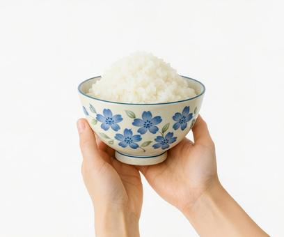 手で持つ炊きたてご飯と和風食器 手で持つ炊きたてご飯と和風食器の写真