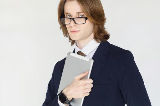 タブレットを抱えるスーツの男性 男性,外国人,欧米人の写真素材