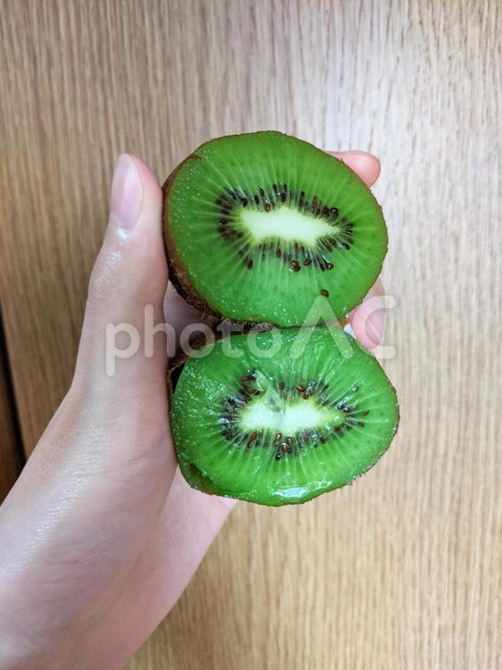 キウイを持つ フルーツ,キウイ,食べ物の写真素材