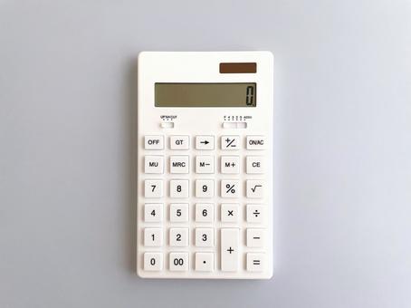 White calculator on a pale blue background, JPG White calculator on a pale blue background, JPG