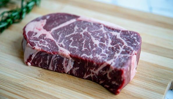 カッティングボードの上の分厚いステーキの写真