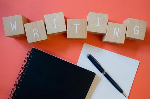 WRITING | The letters "WRITING" made from wooden blocks, notebooks, pens and paper, angielski, test, testuj, JPG