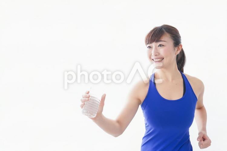 水分を摂取するスポーツウェアの女性 スポーツ飲料水,ヨガ,補給の写真素材