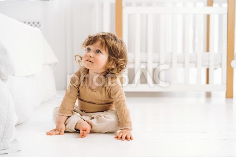 両手を床に付き座り見上げる子供 赤ちゃん,かわいい,お座りの写真素材