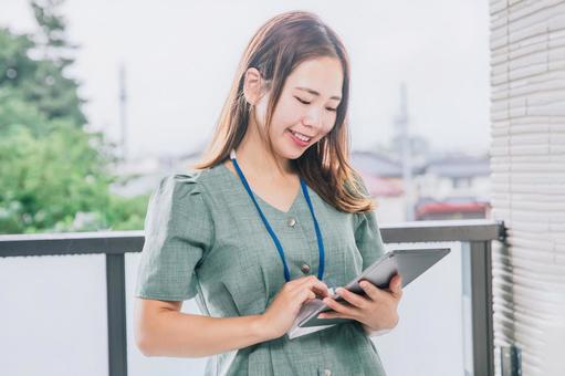 タブレットを使いながら仕事する女性 タブレットを使いながら仕事する女性 ビジネス,働く女性,タブレットの写真素材