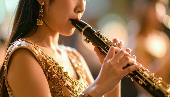 ファゴットを演奏するアジア人女性 ファゴットを演奏するアジア人女性の写真
