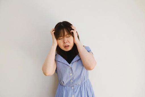 頭を抱える女性 頭を抱える女性の写真