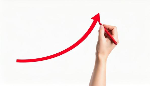 右上がりの上昇カーブを赤ペンで書く手の写真