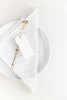 Cross and paper tag on white plate, JPG