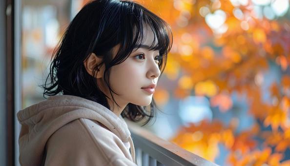 バルコニーから紅葉を眺める女性 バルコニーから紅葉を眺める女性の写真