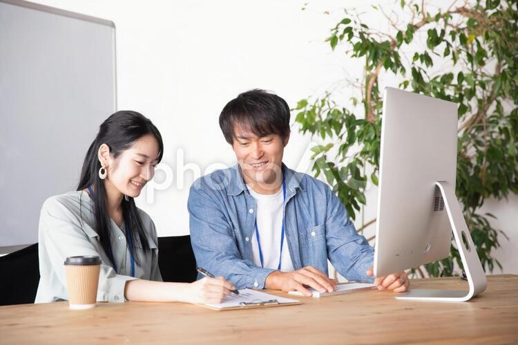 オフィスでミーティングする男女の会社員 ミーティング,打ち合わせ,クリエイターの写真素材