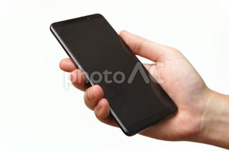 スマホを操作する男性の片手-白背景 スマホ,スマートフォン,手の写真素材