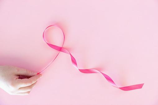 ピンク色のリボンと女性の手 手,手のみ,手元の写真素材