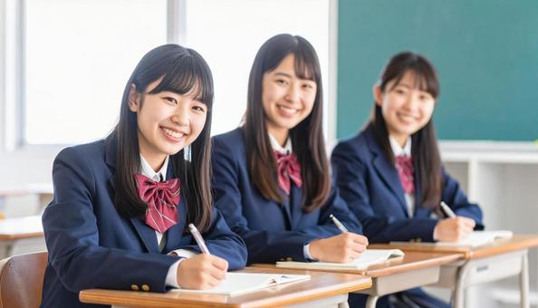 教室で勉強する女子高校生たち 教室で勉強する女子高校生たちの写真