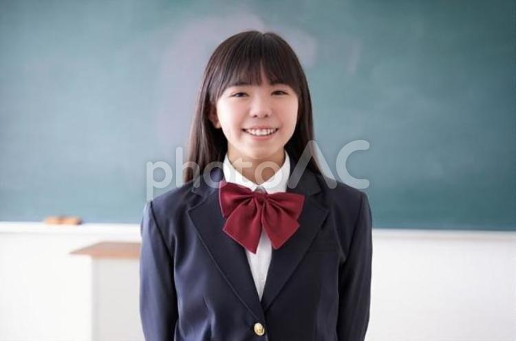 教室で笑顔で立つ日本人女子中学生 中学生,女子,日本人の写真素材