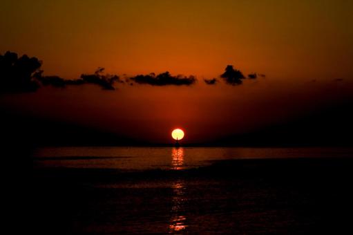 <素材>秋の海に沈む太陽と沖の灯台 <素材>秋の海に沈む太陽と沖の灯台の写真