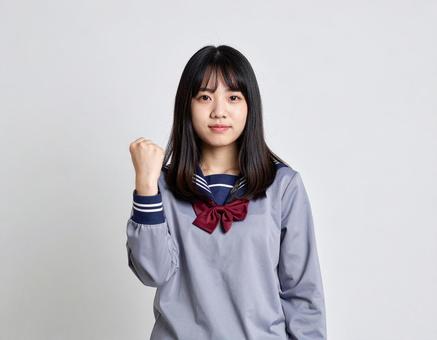 ガッツポーズをする女子生徒のイメージ ガッツポーズをする女子生徒のイメージの写真