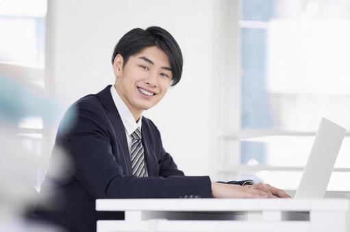 Japanese male businessman working on a laptop with a smile, предприниматель, улыбка, человек, JPG