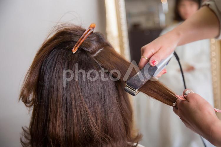 ヘアアイロンを使う美容師 ヘアアイロン,アイロン,コテの写真素材