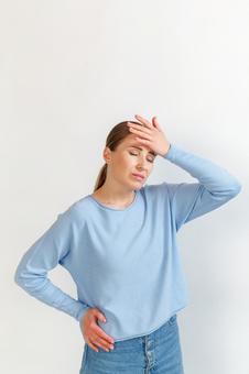 額に手を当てる女性 生理,月経,女性の写真素材