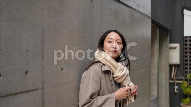 路地で待ち合わせをするマフラー姿の女性 ２０代女性,路地,神楽坂の写真素材