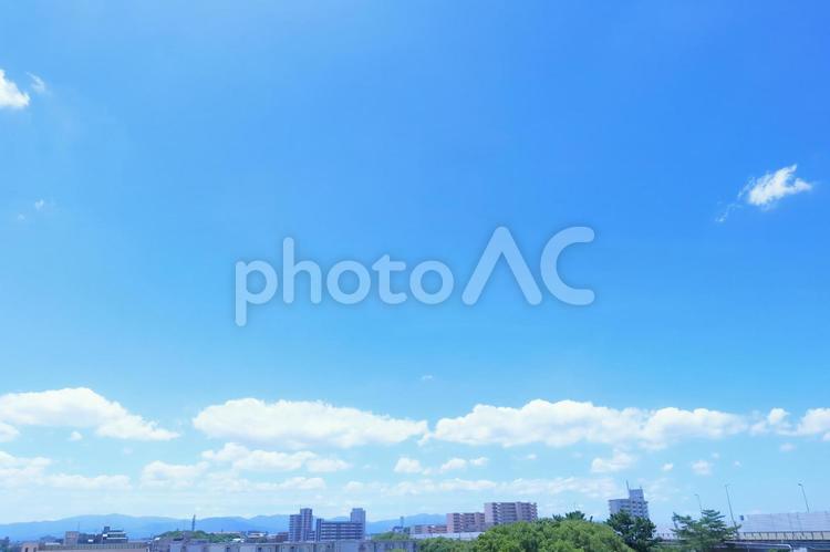 青空と夏の白い雲が浮かぶ街並みと空の背景 空,青空,背景の写真素材