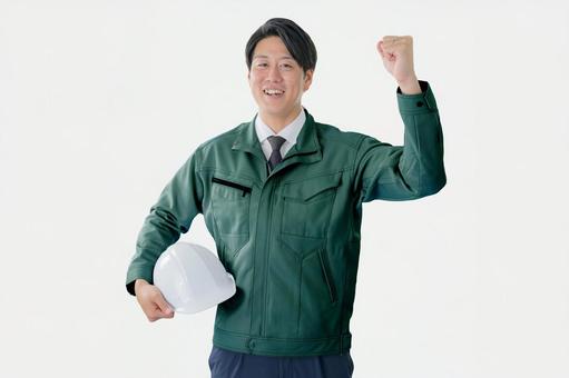 ガッツポーズする爽やかな作業員 作業員,男性,住宅の写真素材