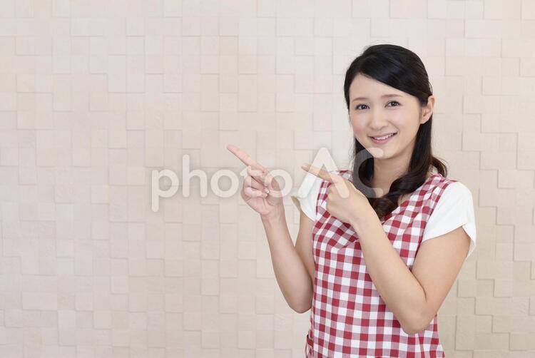指示する笑顔の女性 女性,女,主婦の写真素材
