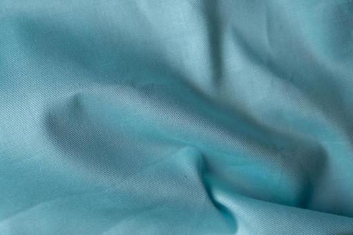 水色布の繊細な折り目模様の写真