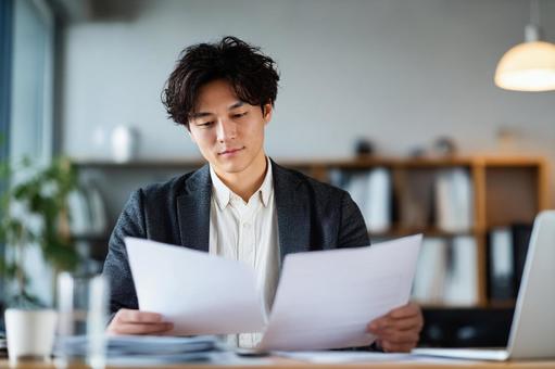 書類をチェックしているビジネスマンの写真