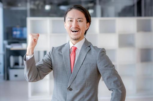 Businessman pumping his fist, JPG