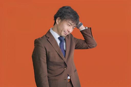 頭を押さえるビジネスマン 男性,悩む,考えるの写真素材