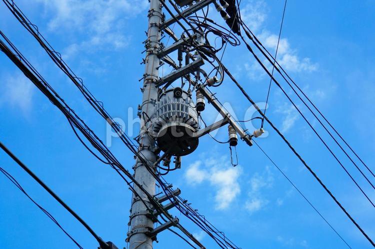 青空と電線と電柱に取り付けられた変圧器 変圧器,電気,パワーの写真素材