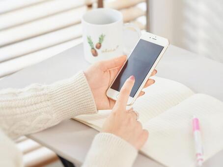 Image of a woman touching a smartphone Image of a woman touching a smartphone