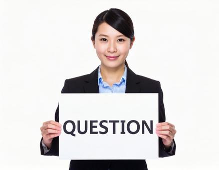 QUESTIONと書いたボードを持つ女性 QUESTIONと書いたボードを持つ女性の写真