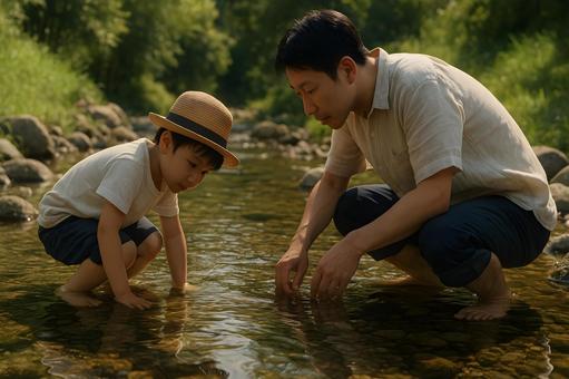 川原で親子の水辺体験の写真