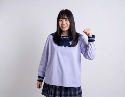 ガッツポーズをする女子生徒のイメージ ガッツポーズをする女子生徒のイメージの写真