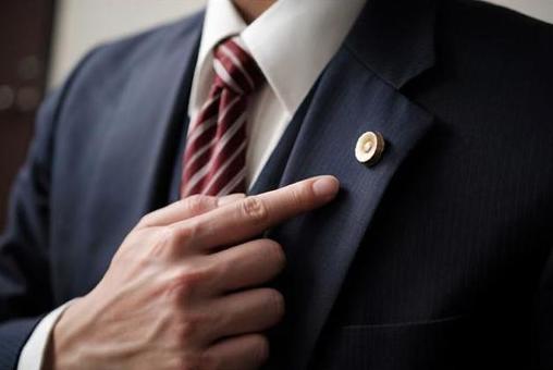 Up of a lawyer pointing at a lawyer badge Up of a lawyer pointing at a lawyer badge