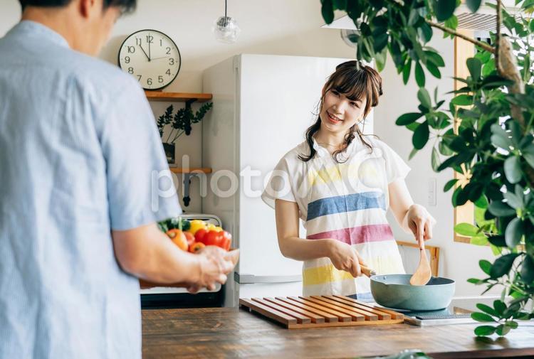 一緒に料理を作る男女（夫婦・手伝う） 料理,手伝う,妻の写真素材