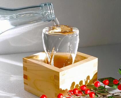 注ぐ日本酒、正月 日本酒,注ぐ,南天の写真素材