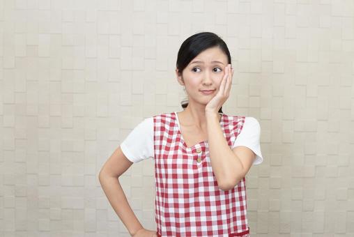 困惑するエプロン姿の女性 困惑するエプロン姿の女性 女性,考える,疑問の写真素材